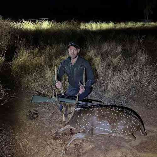 Jamie with deer at night